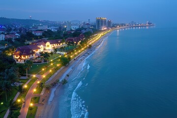 Fototapeta premium Scenic aerial view of cityscape and beach at dusk