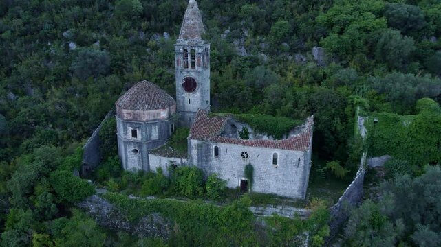 Aerial view of abandoned church ruins in mountainous forest, Prcanj, Kotor Bay, Montenegro.