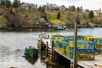 modern steel lobster traps on a wharf on st margarets bay nova scotia with fishing boats room for...