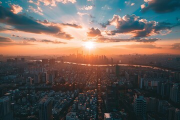 Sunset over a dense cityscape with a river flowing through it