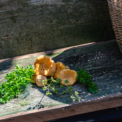 still life with various vegetables on a wooden board, wicker basket in the background, healthy vegetarian diet