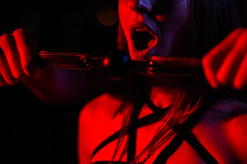 A man gags a woman. BDSM concept.
