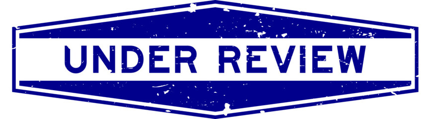 Fototapeta premium Grunge blue under review word hexagon rubber seal stamp on white background
