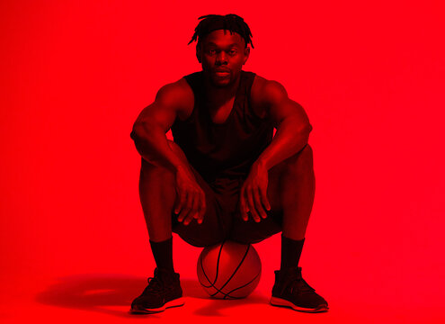 Basketball, fitness and portrait with man in red filter lighting for challenge, game or performance. Break, exercise and sports with African person in studio for competition, health or recreation