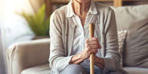 Ageing woman with cane at nursing home. A senior woman relaxes at a hospital with a crutch at an assisted living residence.