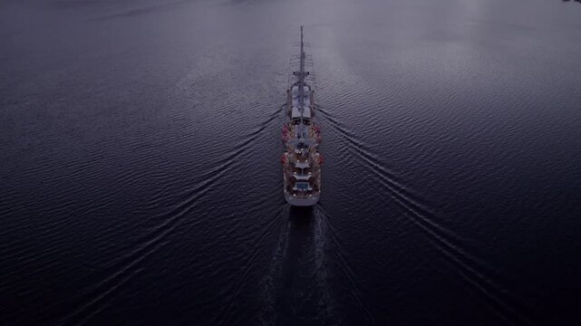 Aerial view of serene Kotor Bay with luxury cruise ship MSY Wind Surf at sunrise, Montenegro.