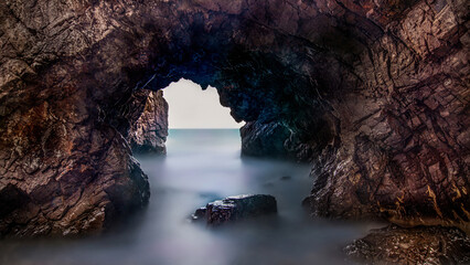 Long exposure of wave and rock of Jeonchon Yonggul Cave on the beach of Jeonchon-ri against horizon near Gampo-eup, Gyeongju-si, South Korea
