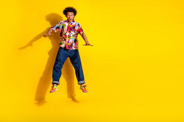 Full body portrait of nice funky young man jump fall empty space wear shirt isolated on vibrant yellow color background