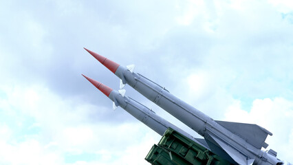 Pair of Military Missiles Pointing Skyward. Two military missiles ready for launch, captured against a clear sky. The image highlights the precision and readiness of modern weaponry.