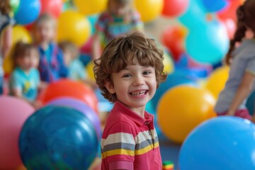 Obraz premium A child beams with happiness while playing with colorful balls in a bustling play area, capturing the spirited and entertaining nature of childhood playtime.