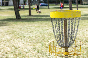 People playing flying disc golf sport game in the public park