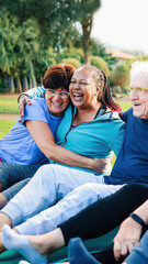 Senior friends, Happy older people have fun after yoga sport class sitting outdoors in park city. Healthy lifestyle