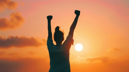 Silhouette of a victorious person with raised arms against a vibrant sunset, symbolizing success, triumph, and achievement.