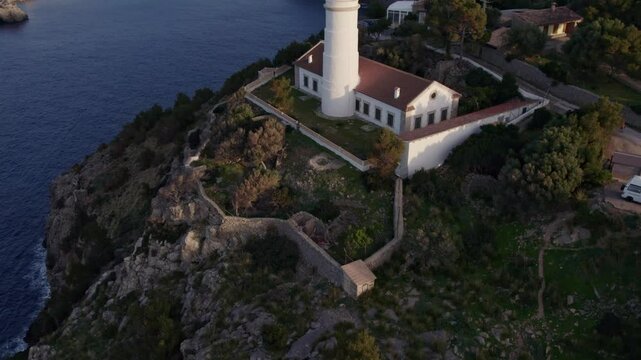Aerial view of picturesque Soller at sunset with coastal cliffs and lighthouse, Mallorca, Spain.