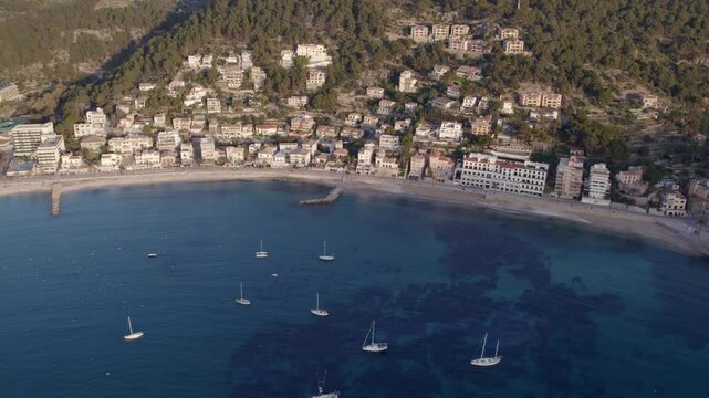 Aerial view of seaside town Soller at sunset with Mediterranean sea and yachts, Mallorca, Spain.