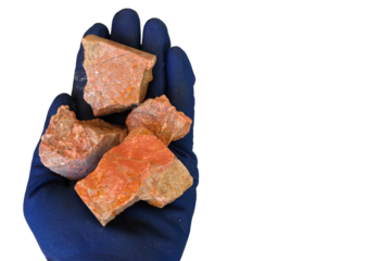 Xenotime rare earth elements ore, hand, blue protective glove. Transparent background. Contain Yttrium (Y), Dysprosium (Dy), Terbium (Tb). Used in permanent magnets, electric vehicles, wind turbines