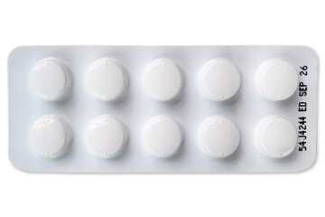 Small pills or tablets in a white blister pack with expiration date text isolated on white background with clipping path. Top view, Flat lay. Drugs Packaging, Healthcare and medicine concept.
