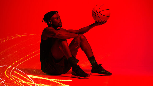 Basketball, fitness and training with man in red filter lighting for challenge, game or performance. Exercise, long exposure and sports with African person in studio for competition or recreation