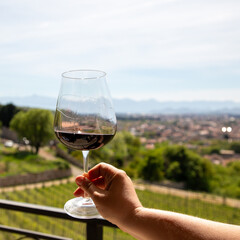 Glass with red wine in hand. Close-up
