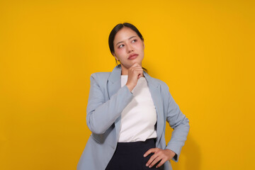 Young businesswoman is deep in thought, her hand resting on her chin as she contemplates a...