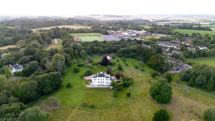 An elegant white washed country house set amongst trees and fields on the outskirts of Wimborne Minster in Dorset