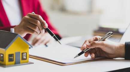 Businesswoman discusses with real estate agent, negotiates and signs contract for purchase of house and land. Wills and inheritance.