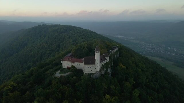 Aerial view of castle, mountain, forest, and trees at sunrise, Burg Teck, Baden-Wurttemberg, Germany.