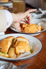 Escabeche sandwich Peruvian breakfast food table with lomo saltado and pejerrey sandwich