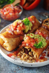 A typical dish of Mexican cuisine - Chimichanga, made of tortilla with different ingredients