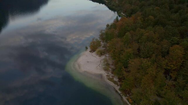 Aerial view of forest-lined lake and mountain, Bohinj, Slovenia.