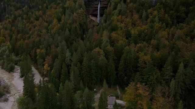 Aerial view of majestic forest, waterfall, and mountain by Triglavska Bistrica river, Kranjska Gora, Slovenia.