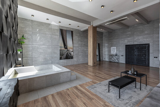 stylish minimalistic restrained modern interior of the apartment, a spacious room with a swimming pool, large panoramic windows overlooking the mountains. without people in the daytime