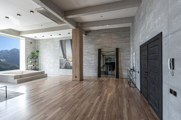 stylish minimalistic restrained modern interior of the apartment, a spacious room with a swimming pool, large panoramic windows overlooking the mountains. without people in the daytime