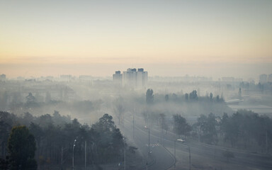 City in a fog. Dusk in a residential neighbourhood -  fog enveloped buildings and trees. 