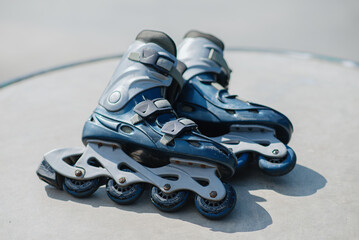 old blue roller skates lying in skate park