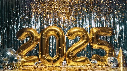 Gold foil balloons spelling out the year 2025 with glitter confetti - Powered by Adobe