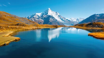 An expansive mountain range is magnificently reflected in a serene and clear lake, portraying the immense beauty and vastness of nature's landscapes in stunning clarity.
