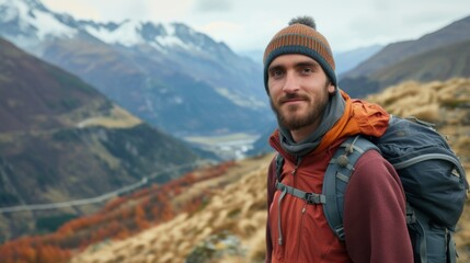 A portrait of a male hiker standing on a mountain trail