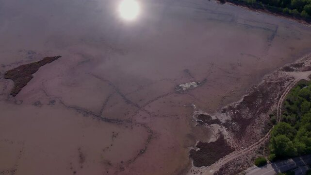 Aerial view of pink lake and town, Zablace, Sibenik, Croatia.