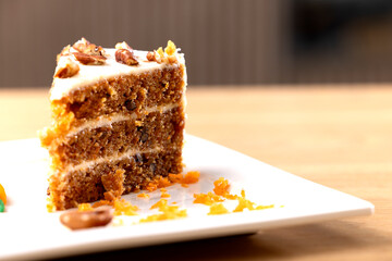 Delicious Slice of Carrot Cake with Cream Cheese Frosting. A mouth-watering close-up of a slice of carrot cake with rich cream cheese frosting. The cake is beautifully layered with moist, carrot