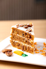 Delicious Slice of Carrot Cake with Cream Cheese Frosting. A mouth-watering close-up of a slice of carrot cake with rich cream cheese frosting. The cake is beautifully layered with moist, carrot
