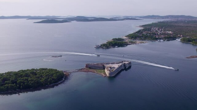 Aerial view of St. Nicholas fortress, canal, Adriatic sea, boat, and island, Zablace, Sibenik, Croatia.