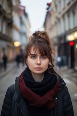 Fototapeta premium A young woman standing in a city street.
