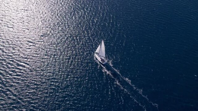 Aerial view of serene sailboat sailing in the blue Adriatic Sea, Sibenik, Croatia.