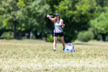Fototapeta premium Woman playing flying disc golf sport game in the nature