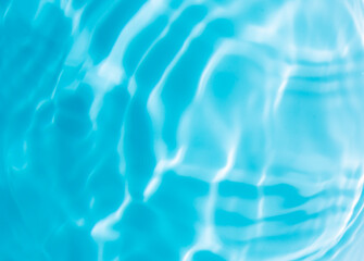 Macro blue water surface,drops on water with circles on a blue background close up