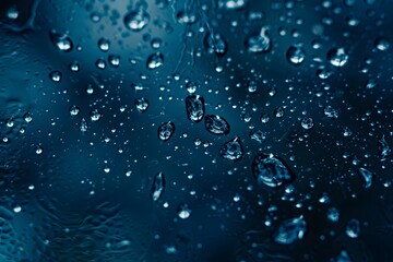 The glass surface's droplet texture. the background is blue. wet surface.