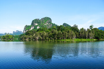 Beautiful clear sky at the swamp. Steam floats on the surface of the water with the reflection of the forest. Landscape with the image of lake Nong Thale, Krabi, Thailand. natural background.