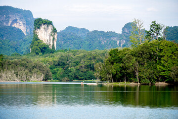 Beautiful clear sky at the swamp. Steam floats on the surface of the water with the reflection of the forest. Landscape with the image of lake Nong Thale, Krabi, Thailand. natural background.