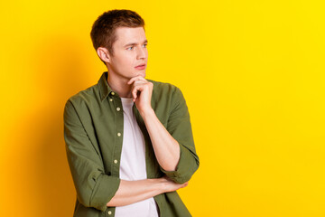 Photo of handsome young man wear khaki clothes arm touch face look empty space isolated on vivid...
